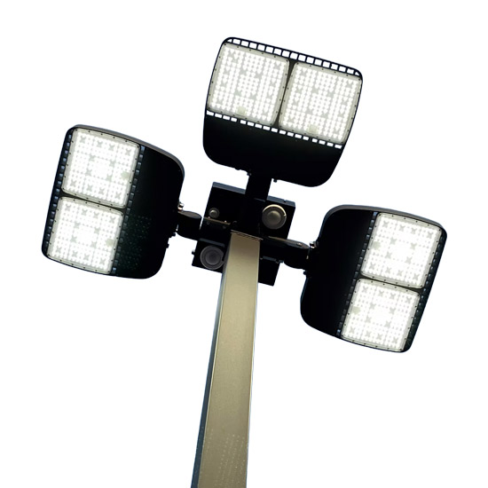 2026 Is a Time for Action in Dealership Operations; Four bright LED floodlights are mounted on a tall pole against a white background. The lights are angled outward, creating a modern, industrial feel.