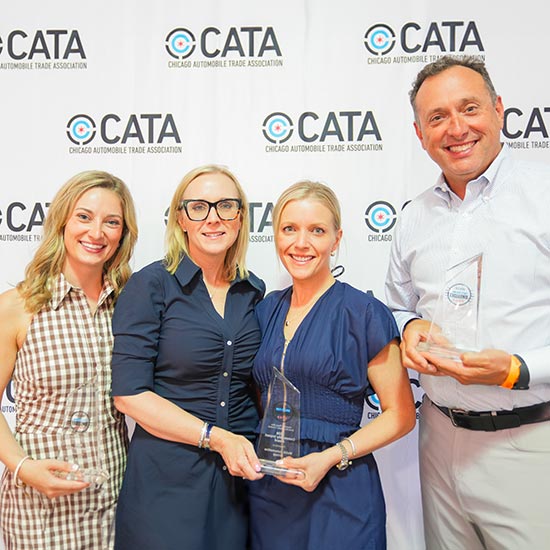 Four people standing in front of CATA wall